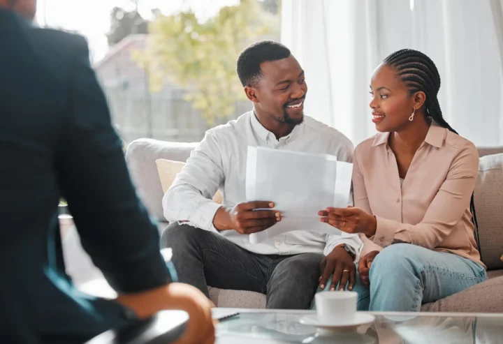 Shot of a young couple meeting with their insurance agent.