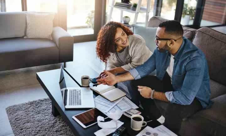 Home couple and documents for finances laptop and planning for savings
