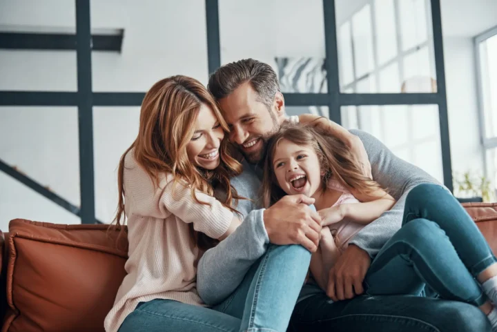 Happy young family bonding together at home